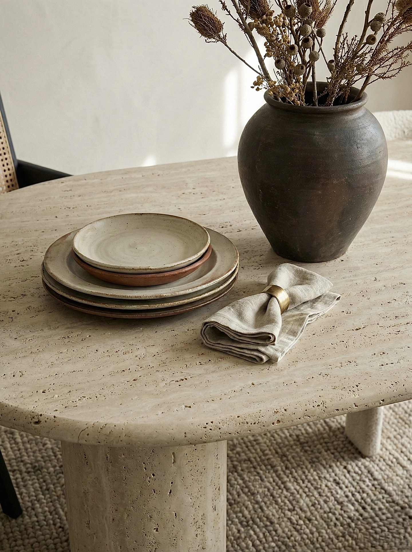 A low-sheen stone table in a collected interior reference.