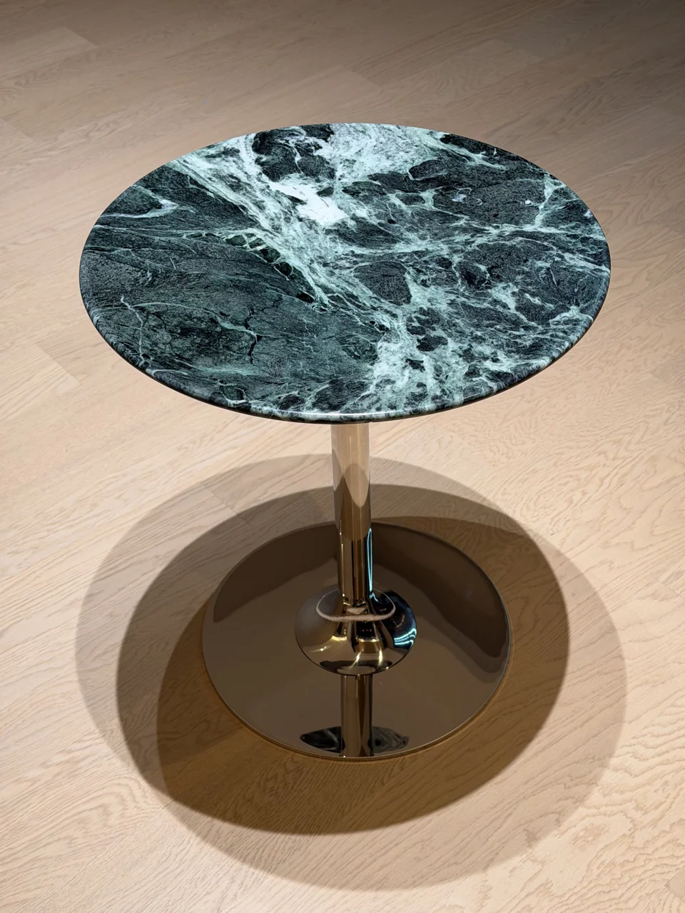 Small green stone side table made from a compact round top