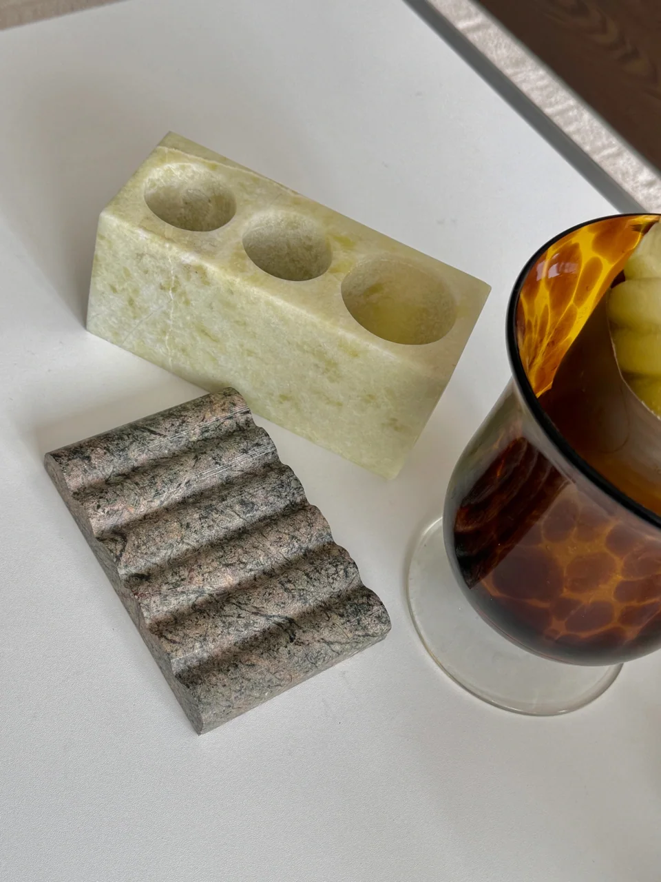 Small stone trays, vessels and accessories on a tabletop