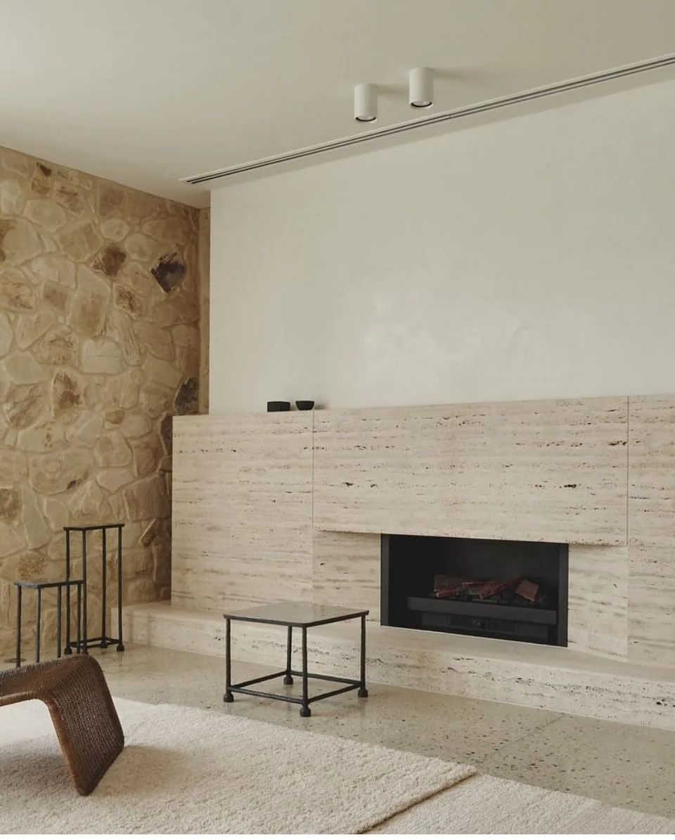 Contemporary travertine fireplace with a coordinated hearth
