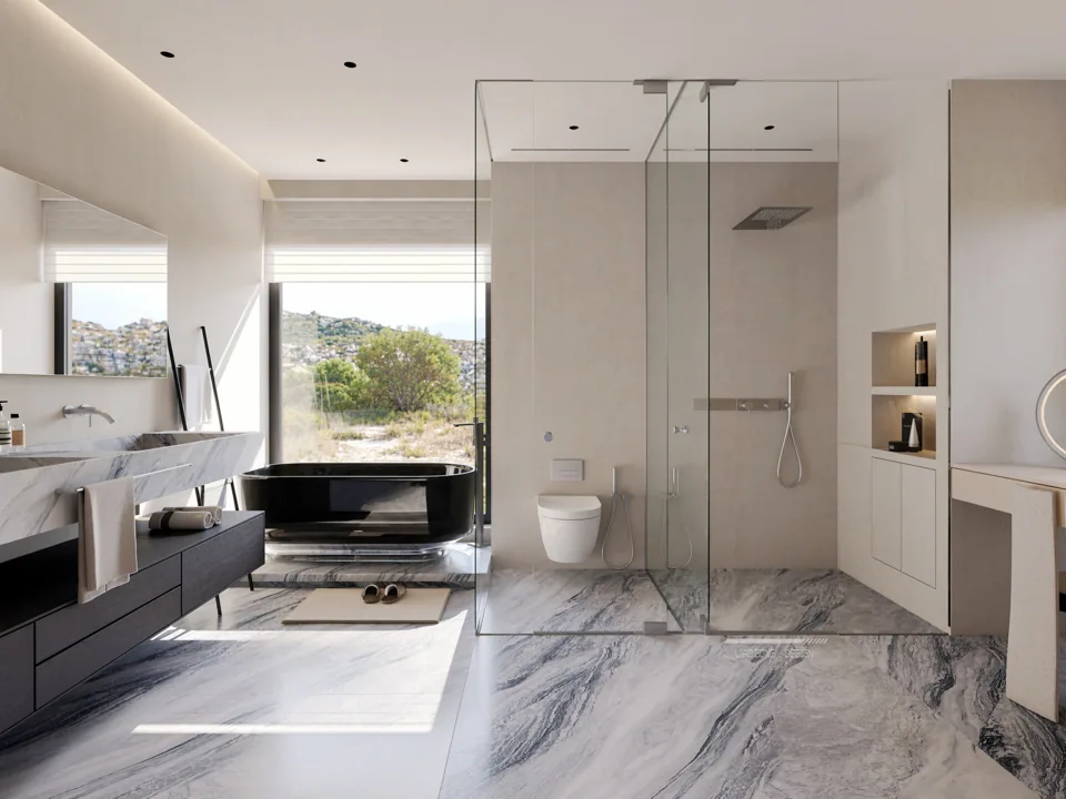 A light bathroom with veined stone surfaces and a dark bath