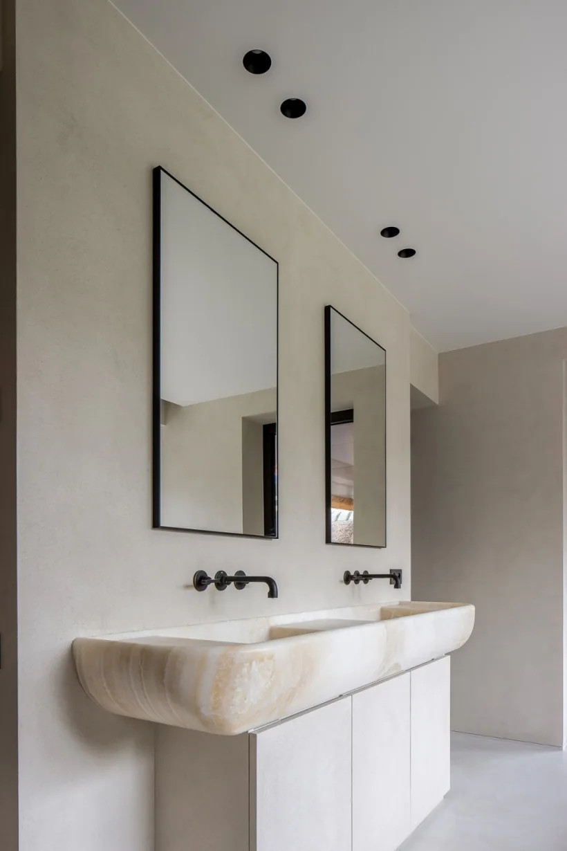 A pale integrated double basin below two mirrors