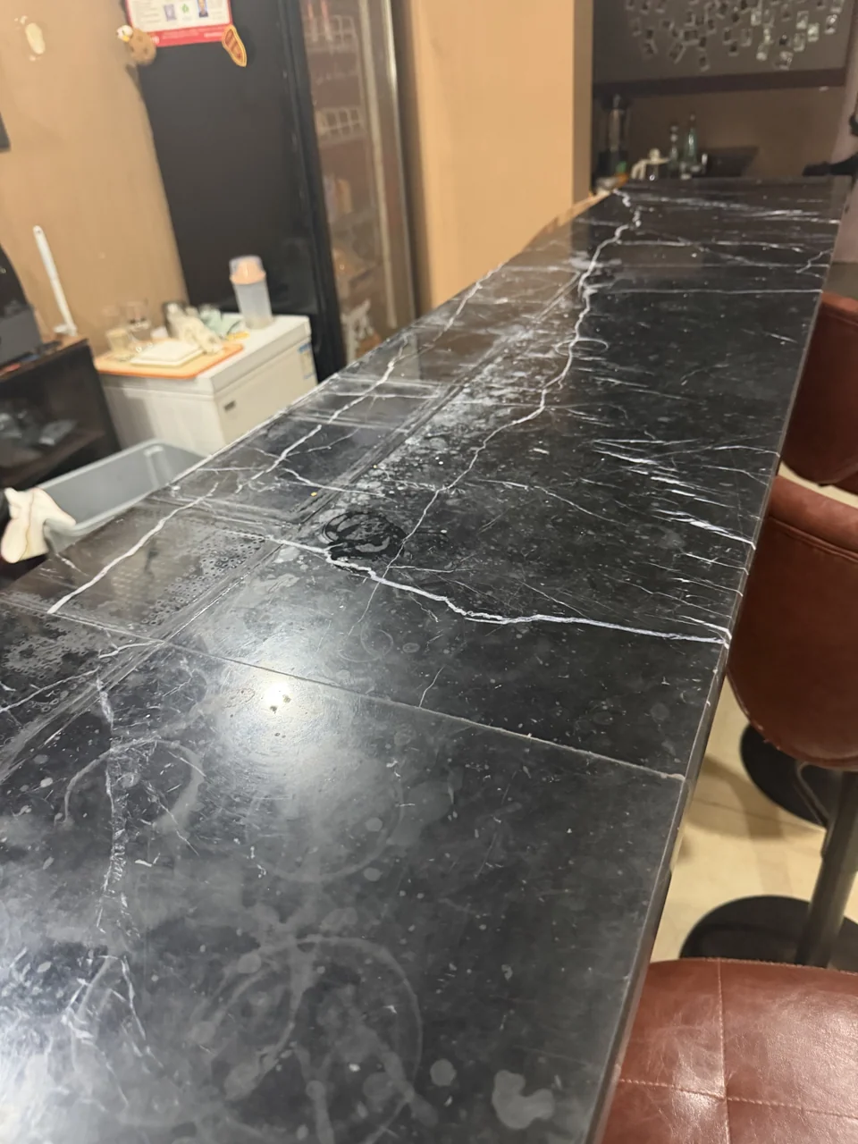 Dark marble table showing surface marks under reflected light