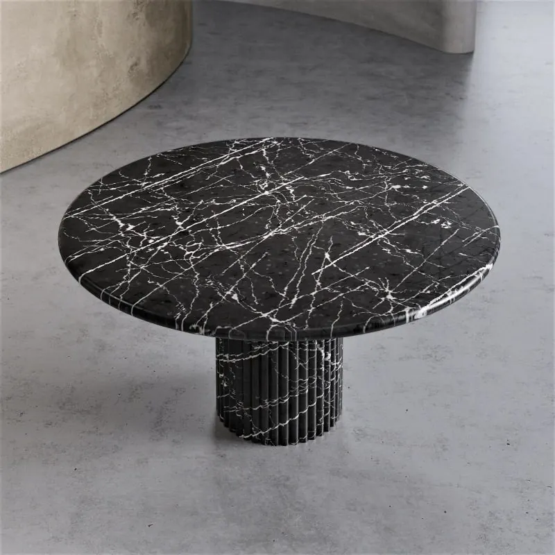 Round black marble table on a fluted pedestal