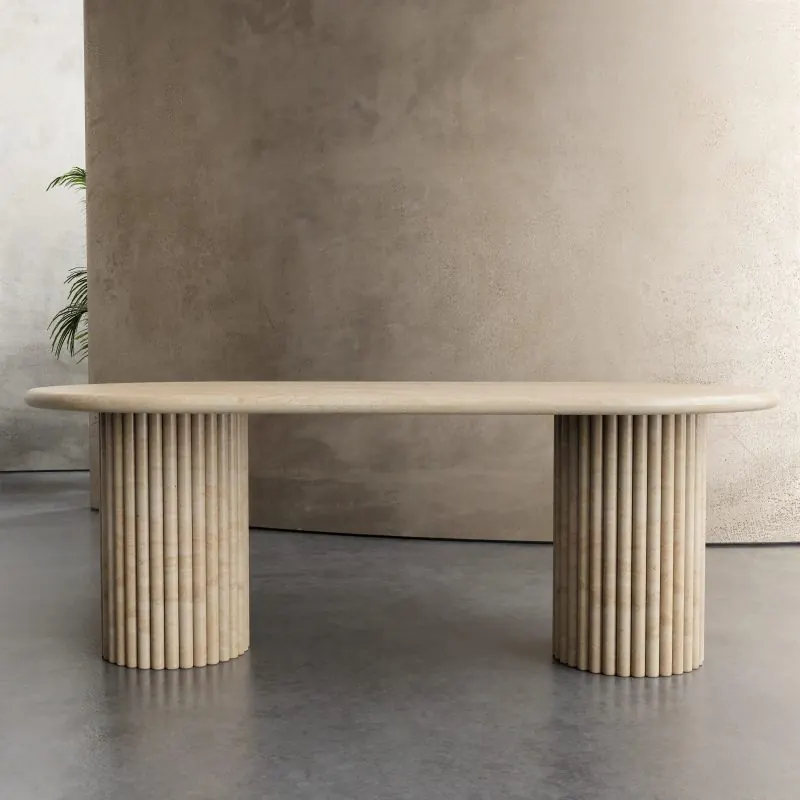 Oval travertine dining table on fluted legs
