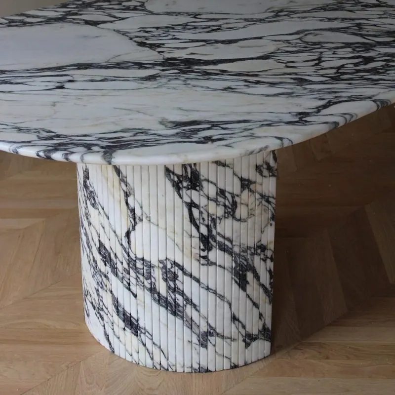Fluted half-drum base under the top