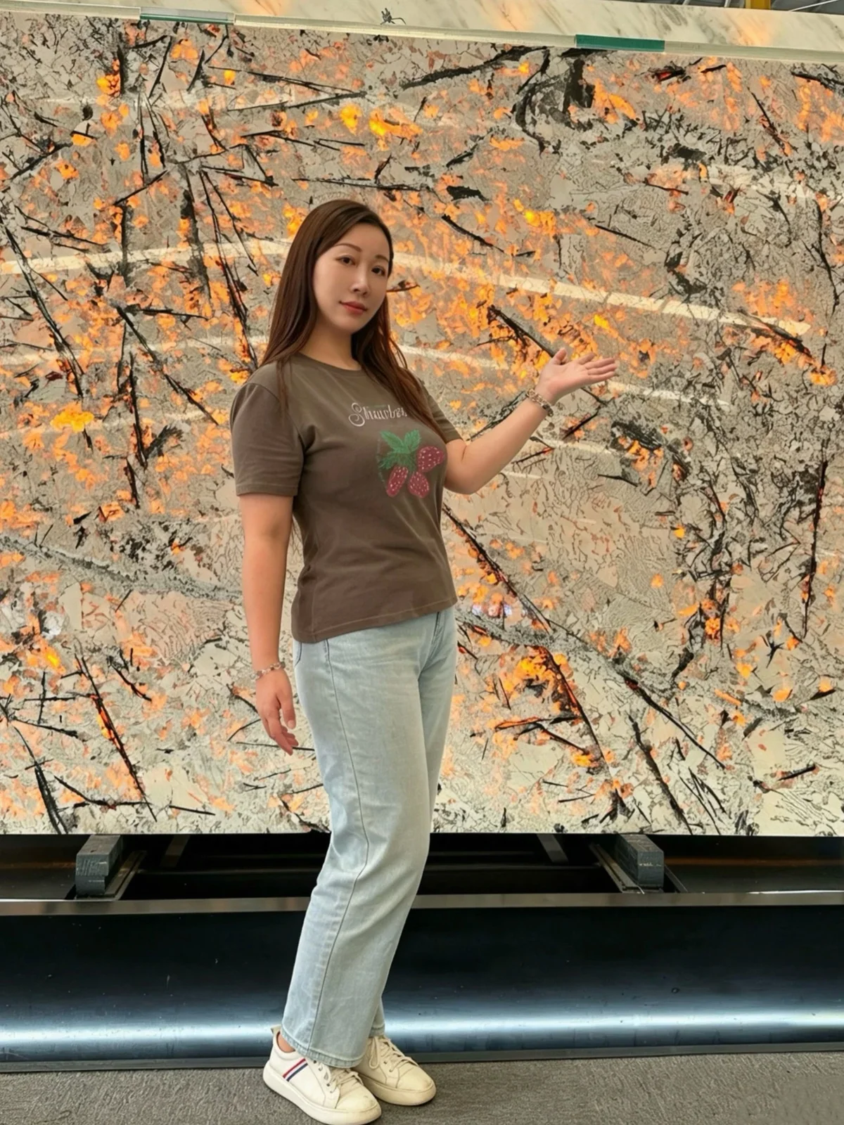 Person beside a large veined slab